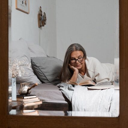 Old_Woman_Reading_In_Bed